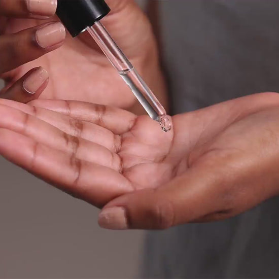 Skincare model is applying Dermiotic to face